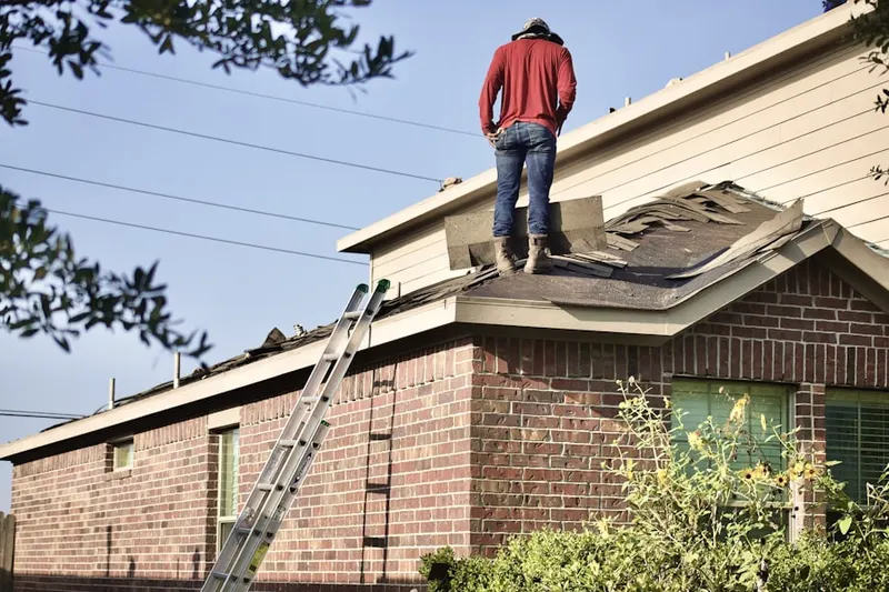 Professional roofer working on a residential roof in Raytown